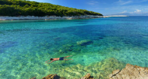 A high-energy portrayal of water sports in Kefalonia, Greece, showcasing thrilling adventures and adrenaline-pumping activities such as jet skiing, snorkeling, parasailing, and paddleboarding. Dive into the exhilarating world of aquatic fun and make a splash in the crystal-clear waters of Kefalonia.